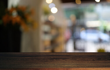 Empty wooden table in front of abstract blurred background of coffee shop . can be used for display or montage your products.Mock up for display of product