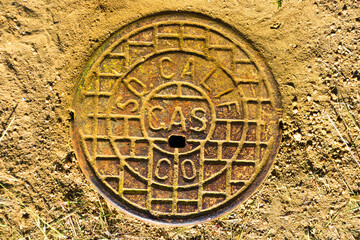 Colorful utility cover is cast with striking patterns and conveys an aging industrial era