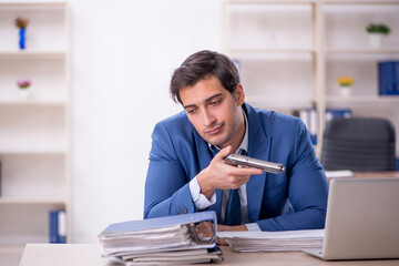 Young male employee committing suicide at workplace