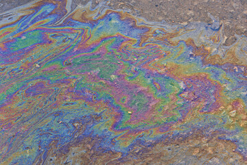 Fototapeta na wymiar spilled gasoline rainbow background, industrial hazard spill pollution, abstract texture multicolored