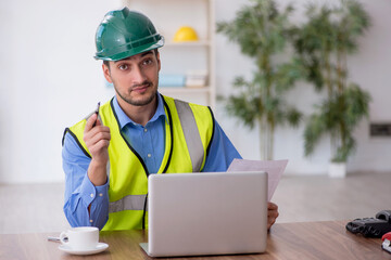 Young male architect working in the office
