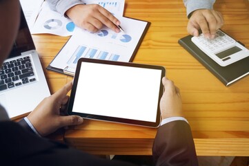 Business People using tablet, touchpad at meeting.