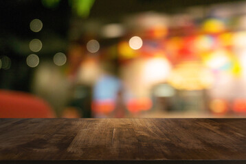 Empty wooden table in front of abstract blurred background of coffee shop . can be used for display Mock up  of product