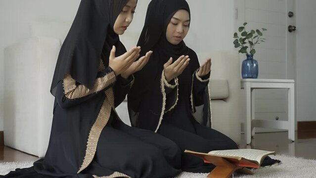 An Asian Muslim women reciting Salah or Salat al-Fatiha passage of the Qur'an, in a single act of sujud called a sajdah or prostrations at home.
The Quran holy book is a public item