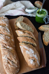 Fresh French home made Baguette Bread with wild garlic on dark background