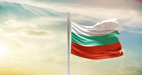 Bulgaria national flag waving in beautiful sky. The symbol of the state on wavy silk fabric.