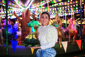 Portrait Beautiful Young Asia woman with Traditional Thai costume hold Banana leaf cockerel or Kra...