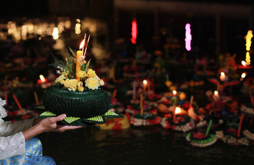 Portrait Beautiful Young Asia woman with Traditional Thai costume hold Banana leaf cockerel or Kra...