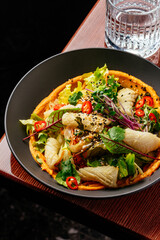 grilled squid with sauce and vegetables in a plate. restaurant m