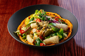 grilled squid with sauce and vegetables in a plate. restaurant m