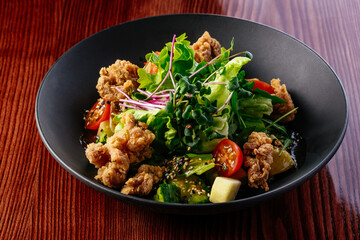 warm salad with chicken, vegetables and herbs. restaurant menu
