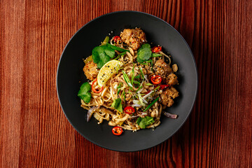 asian noodles with chicken and vegetables. restaurant menu