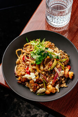 asian noodles with chicken and vegetables. restaurant menu
