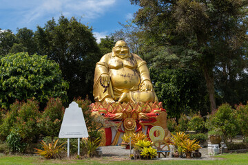 Statue of a golden fat buddha in thailand
