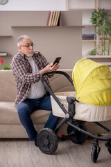 Old man looking after newborn at home