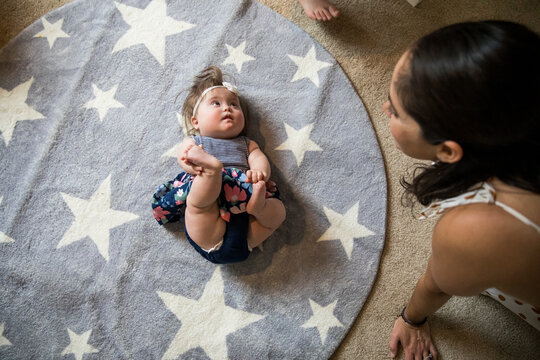 Mother playing with special needs daughter inside