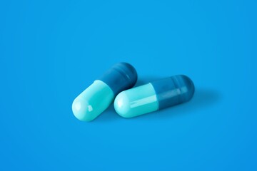 white medical pills lie on a color background.