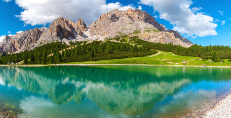 Panoramic view of turquoise water alpine lake in Dolomites mountains, Italy. Lago Son Forca in Italian Alps in sunny day