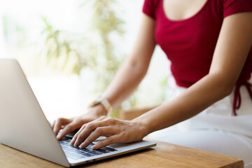 Fototapeta premium Beautiful Asian young woman working in co-working space in coffee shop.