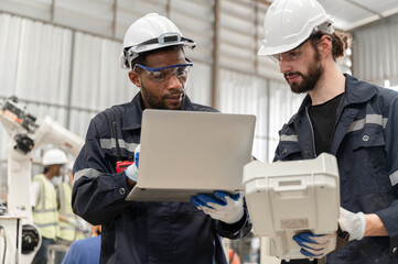 Caucasian and African American technician engineer man use remote control and computer notebook...