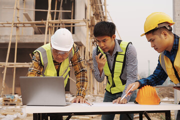Team of engineer and worker checking construction site outdoors Surveyor builder Engineer surveying...