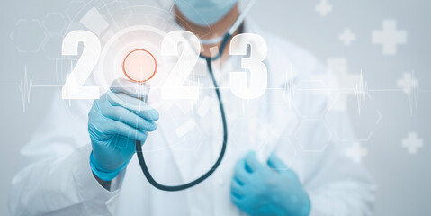 Concept New Year 2023 in medicine and healthcare, Doctor or scientist with a stethoscope Wearing Medical Mask in the white background, health insurance,medical secret, emergency online medical