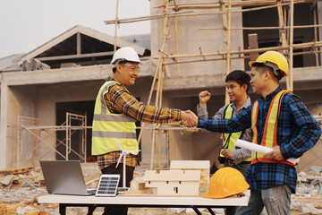 Team of engineer and worker checking construction site outdoors Surveyor builder Engineer surveying work checking schedule for rebuilding project.