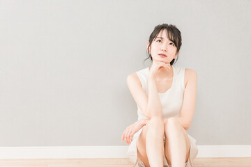 頬杖をついて考える・悩む女性（美容・ダイエット）
