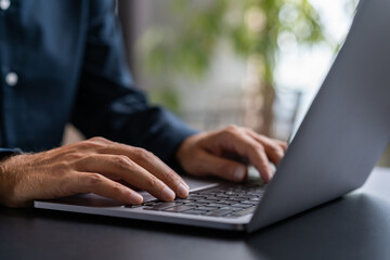 Businessman hands using laptop in office