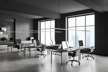 Gray open space office corner with windows