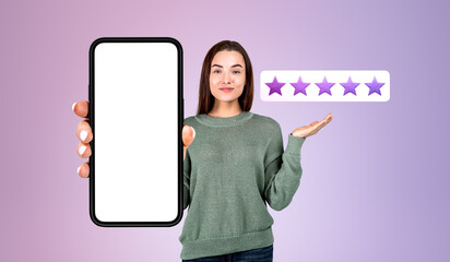 Woman holding a mock up smartphone, giving five stars feedback