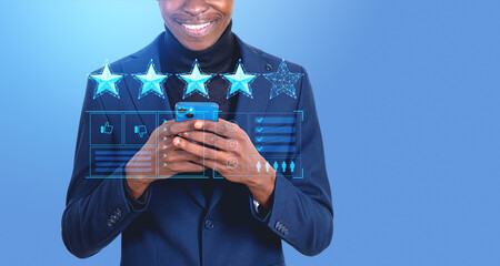 African businessman with smartphone giving star feedback online