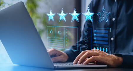 Man with laptop giving four star rating