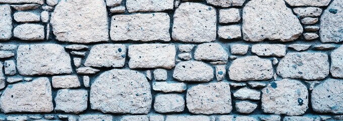 Antique Wall, finished with rubble stone. Grunge Background. Wide Photo