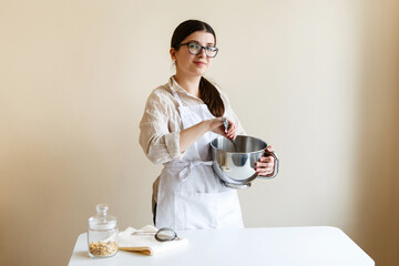 girl confectioner entrepreneur in her kitchen while cooking