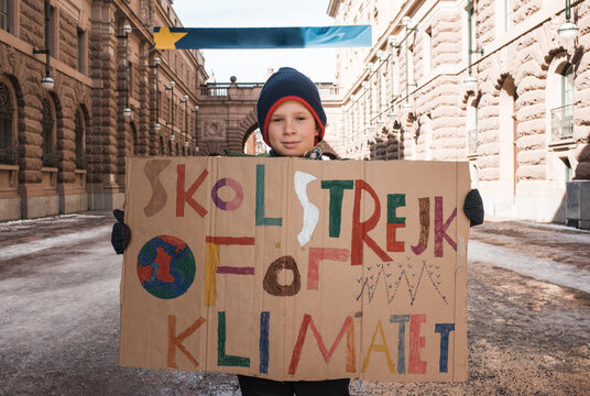 boy outside of Parliament House, Stockholm striking for climate change