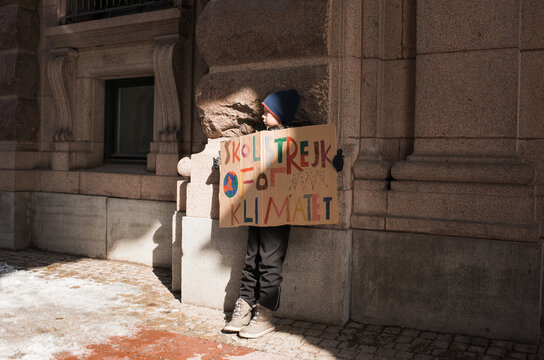 boy outside of Parliament House, Stockholm striking for climate change