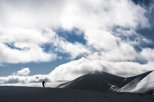 Silhouette of hiker in snowy mountains