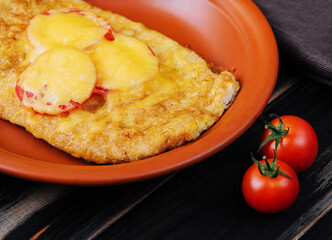 Chicken fillet baked in the oven with cheese and tomatoes