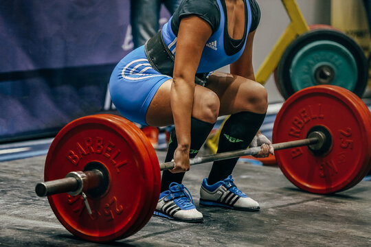 body part and barbells female athlete deadlift in powerlifting. Adidas deadlift boots and singlet weightlifting