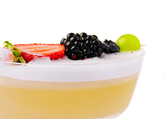 Close up Yellow Cocktail with white foam with berries