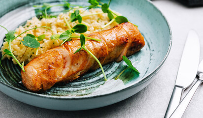 Fried duck fillet with rice on a plate