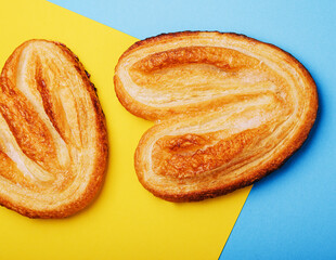 Puff pastry cookies on blue and yellow background