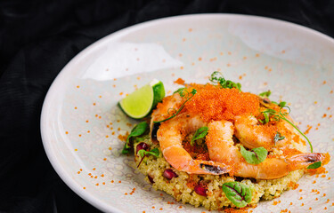 Couscous with vegetables and shrimp under red caviar