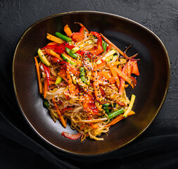 Asian vegetarian udon noodles with vegetables in a bowl