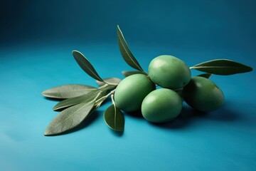  a bunch of green olives with leaves on a blue background.  generative ai