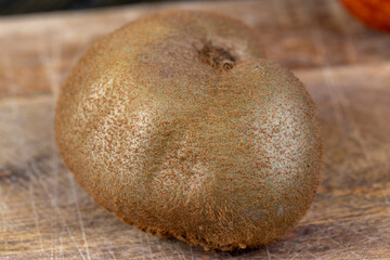 close-up of a green ripe kiwi on a chopping board