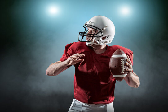 American football sportsman player with ball in action on stadiu