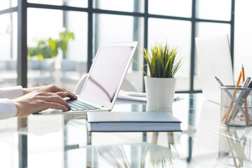 Hands of an executive working on his laptop at the office.
