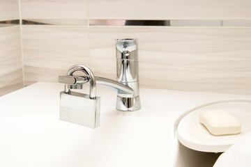 padlock on the water faucet in the bathroom, utility bills